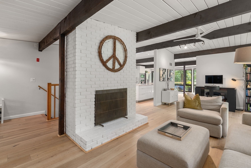 5 Apple Street Sherborn, MA 01770 - Photo 11 of 36 a living room with furniture a clock and a fireplace