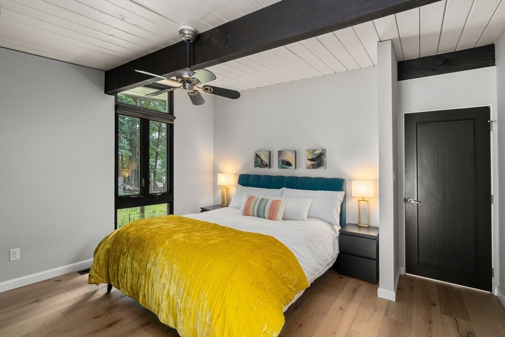 5 Apple Street Sherborn, MA 01770 - Photo 15 of 36 a bedroom with a bed and wooden floor