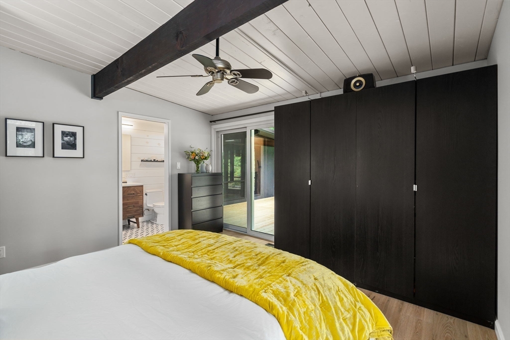 5 Apple Street Sherborn, MA 01770 - Photo 16 of 36 a bedroom with a bed and a chandelier