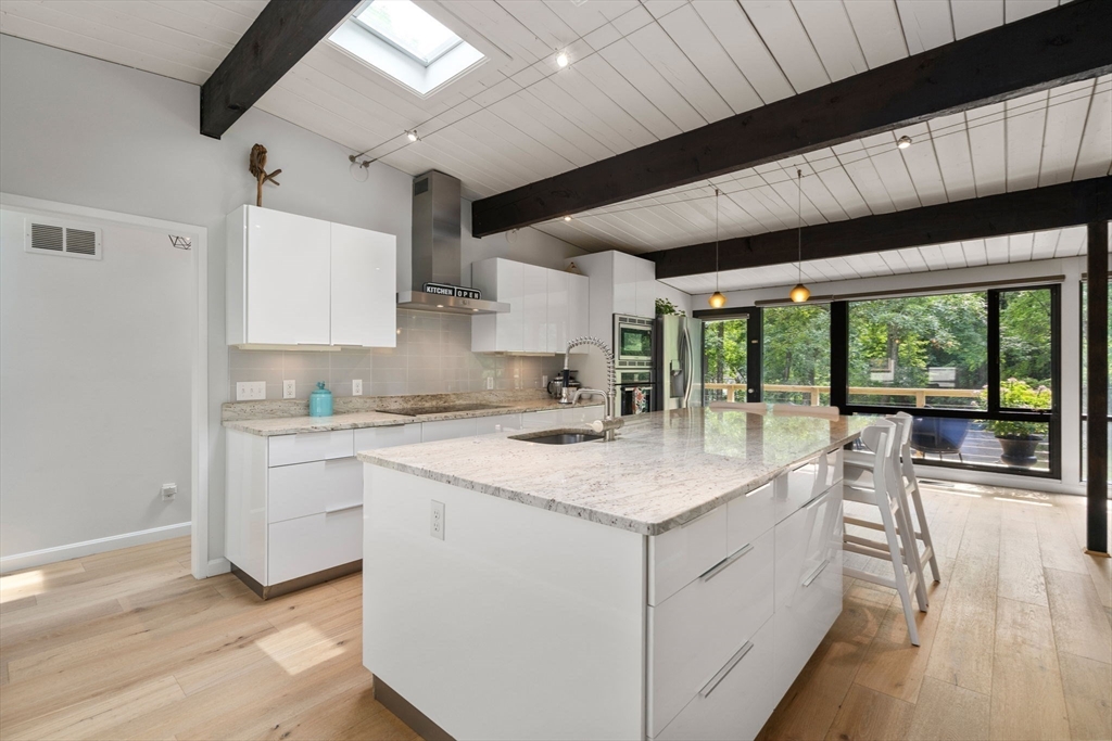 5 Apple Street Sherborn, MA 01770 - Photo 3 of 36 a kitchen with a sink window and cabinets