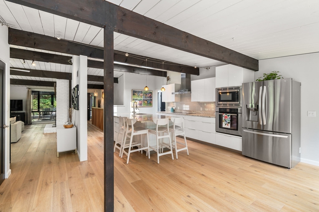 5 Apple Street Sherborn, MA 01770 - Photo 6 of 36 a kitchen with stainless steel appliances a refrigerator a stove oven and white cabinets