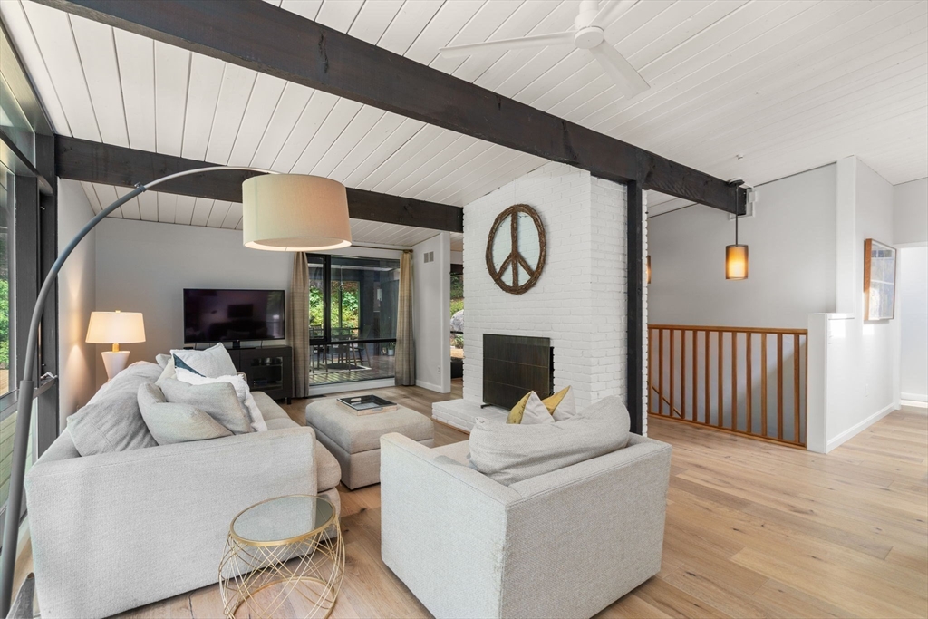 5 Apple Street Sherborn, MA 01770 - Photo 10 of 36 a living room with furniture a clock and a fireplace