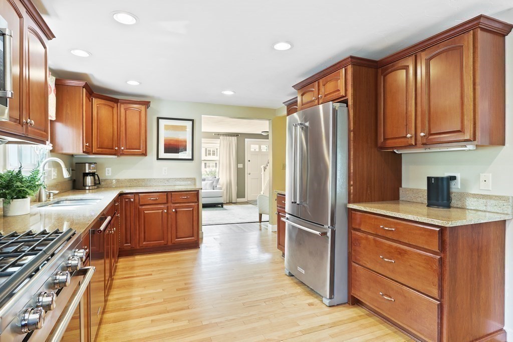 18 Moore Street Natick, MA 01760 - Photo 11 of 42 a kitchen with stainless steel appliances granite countertop a refrigerator sink and cabinets
