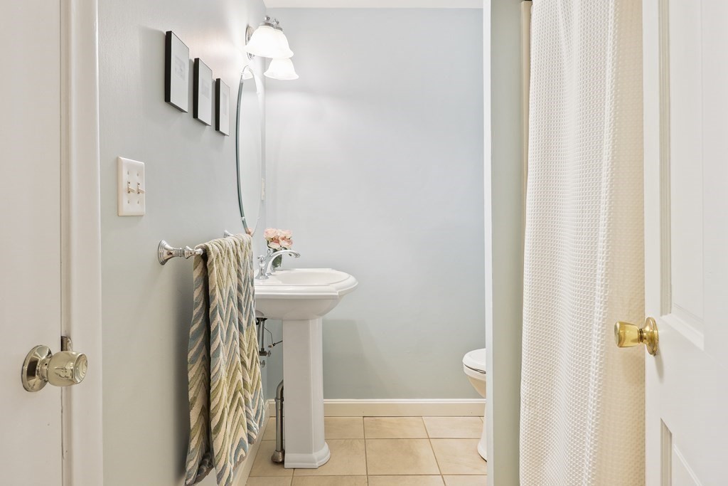 18 Moore Street Natick, MA 01760 - Photo 21 of 42 a bathroom with a sink a mirror and a shower