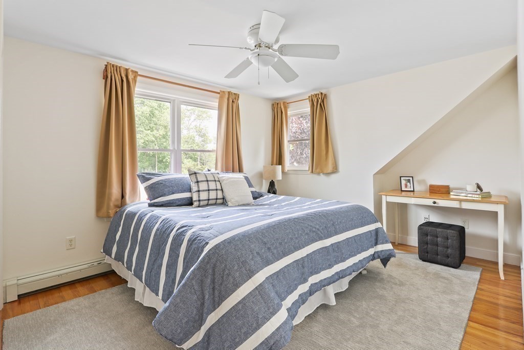 18 Moore Street Natick, MA 01760 - Photo 23 of 42 a spacious bedroom with a bed and a fireplace