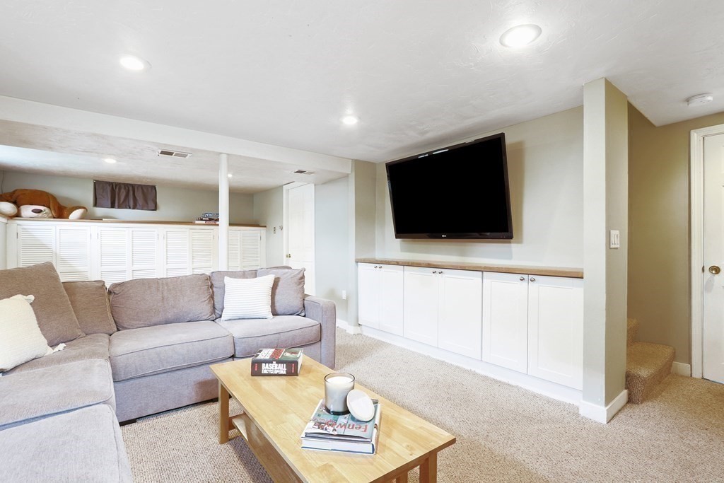 18 Moore Street Natick, MA 01760 - Photo 29 of 42 a living room with furniture and a flat screen tv