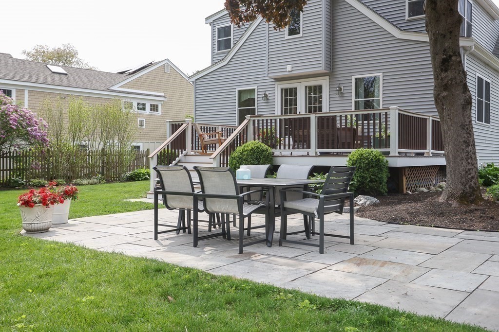 18 Moore Street Natick, MA 01760 - Photo 34 of 42 a view of a house with backyard sitting area and garden