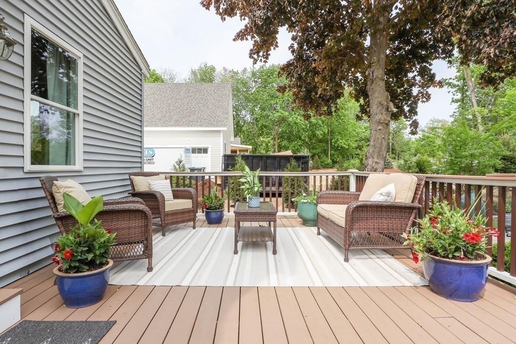 18 Moore Street Natick, MA 01760 - Photo 37 of 42 a view of a patio with couches potted plants and wooden floor