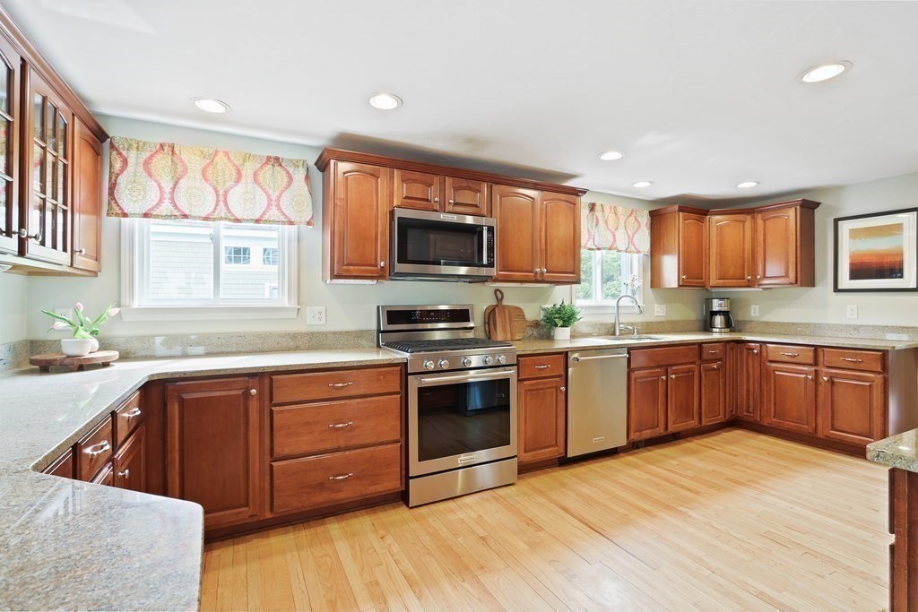 18 Moore Street Natick, MA 01760 - Photo 4 of 42 a kitchen with stainless steel appliances granite countertop a stove a sink and a microwave