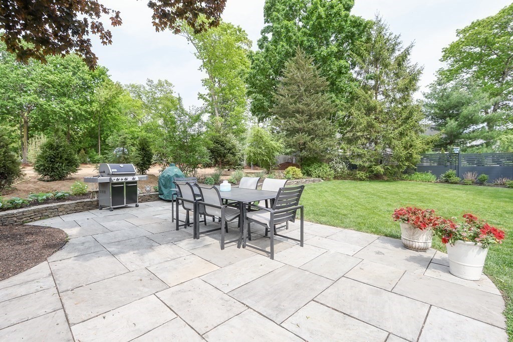 18 Moore Street Natick, MA 01760 - Photo 8 of 42 a view of a dining space with a table and chairs in patio