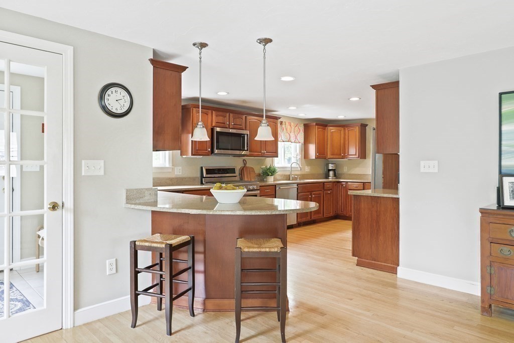 18 Moore Street Natick, MA 01760 - Photo 9 of 42 a living room with stainless steel appliances kitchen island granite countertop furniture and a wooden floor