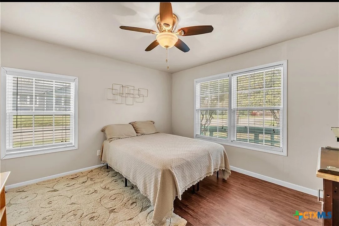 1017 South 6th Street Temple, TX 76504 - Photo 5 of 13 a bed sitting in a bedroom next to a window