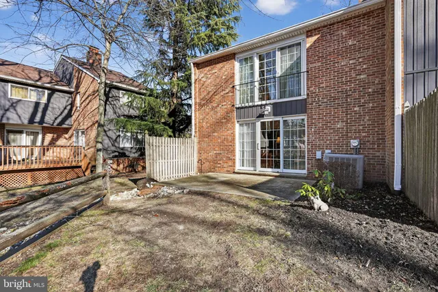 a view of a yard with wooden fence
