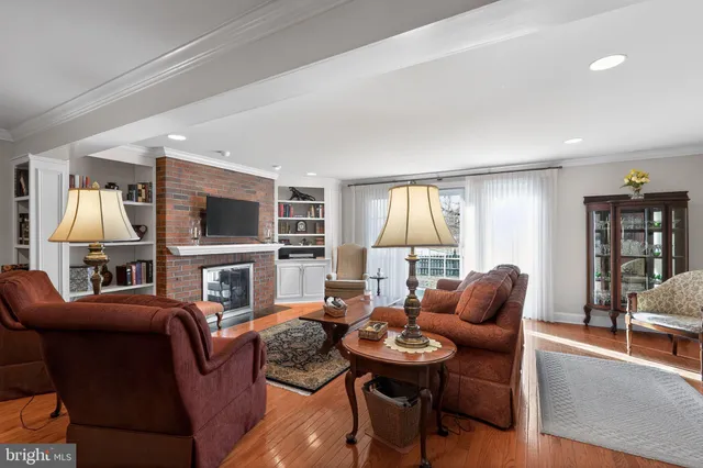 a living room with furniture ceiling fan and a rug