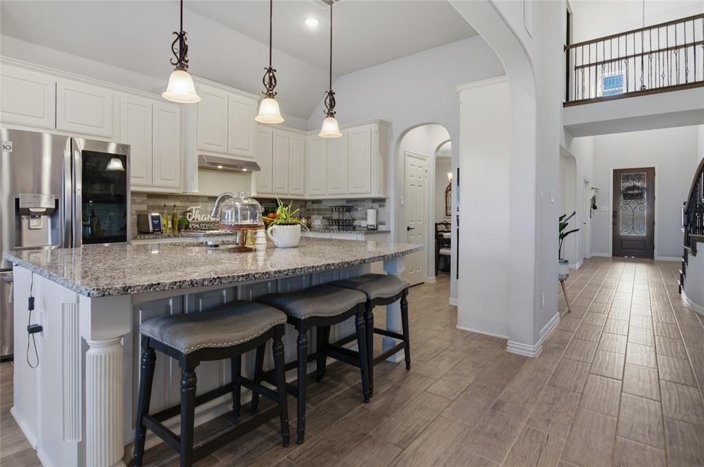464 LeTara Ranch Drive Haslet, TX 76052 - Photo 12 of 37 Kitchen featuring white cabinetry, granite countertops, and stainless steel appliances