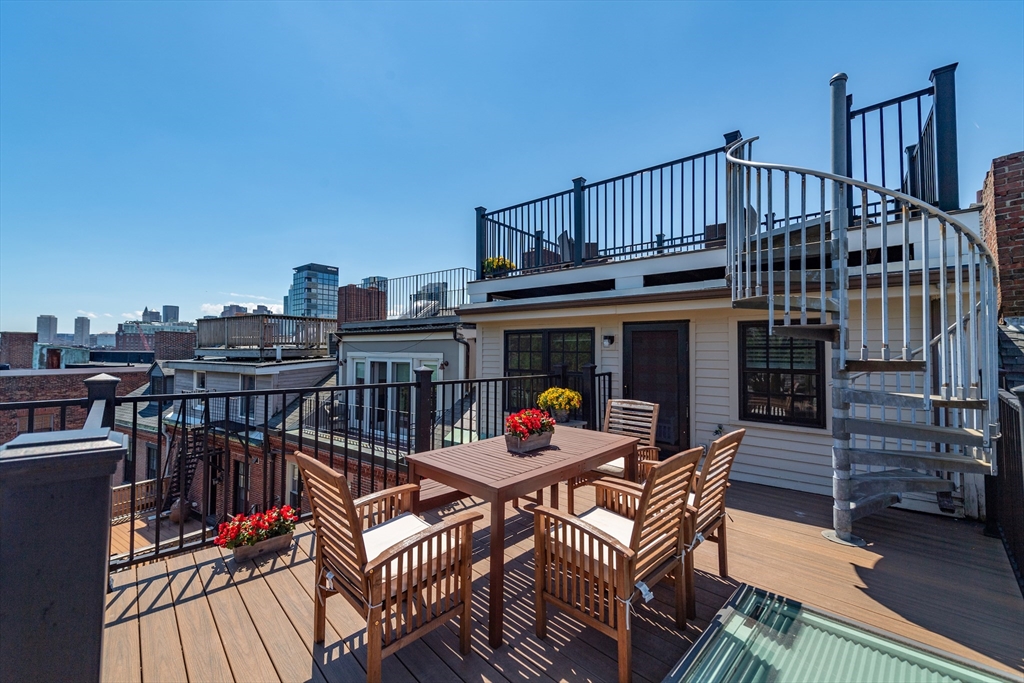 13 Harvard Street, Unit 3 Boston, MA 02129 - Photo 12 of 14 a view of a roof deck with furniture