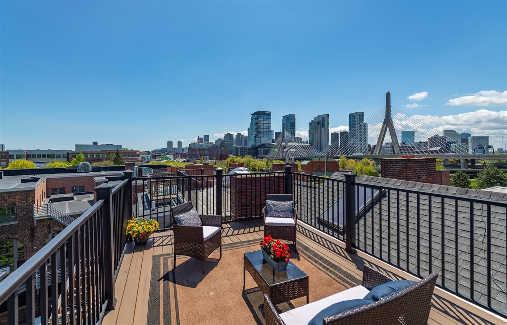 13 Harvard Street, Unit 3 Boston, MA 02129 - Photo 13 of 14 a view of roof deck with two chairs and a lamp