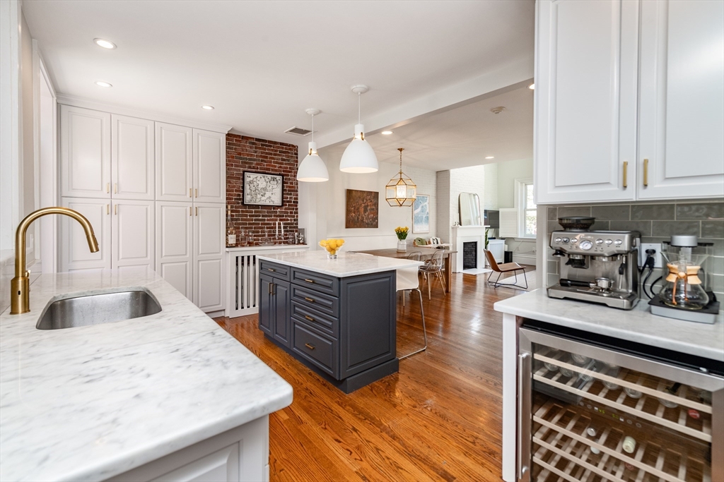 13 Harvard Street, Unit 3 Boston, MA 02129 - Photo 3 of 14 a kitchen with stainless steel appliances granite countertop a stove a sink dishwasher and cabinets with wooden floor