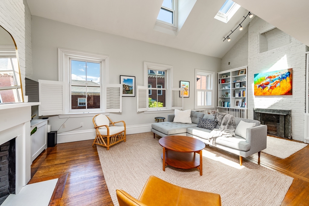 13 Harvard Street, Unit 3 Boston, MA 02129 - Photo 6 of 14 a living room with fireplace furniture and a rug