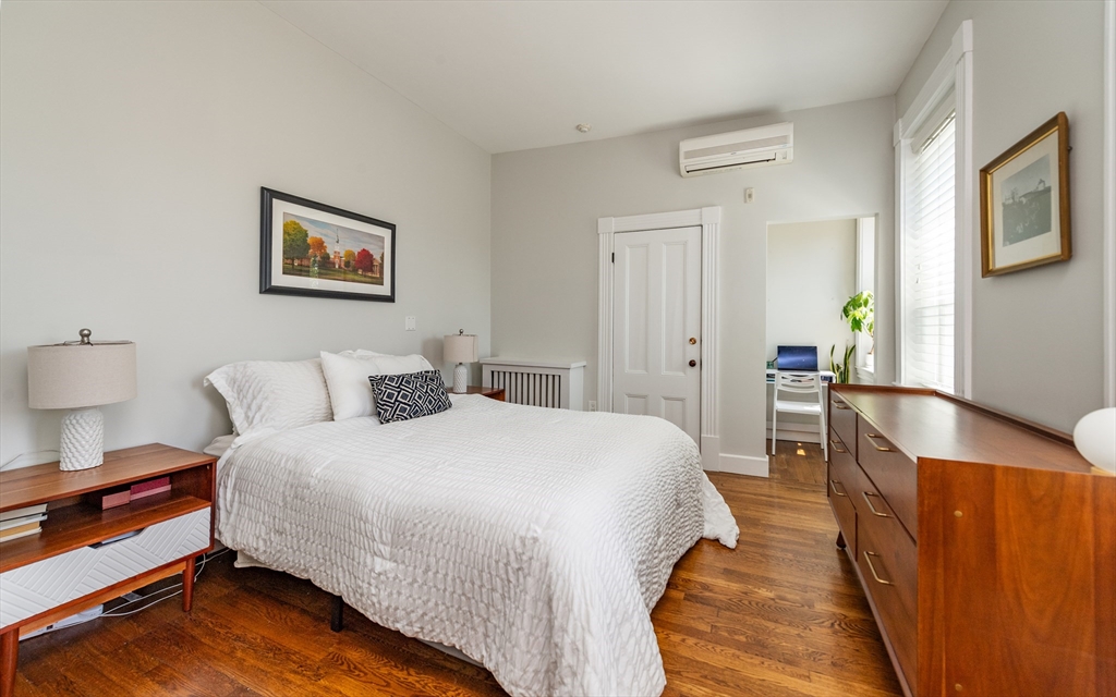 13 Harvard Street, Unit 3 Boston, MA 02129 - Photo 8 of 14 a spacious bedroom with bed and wooden floor