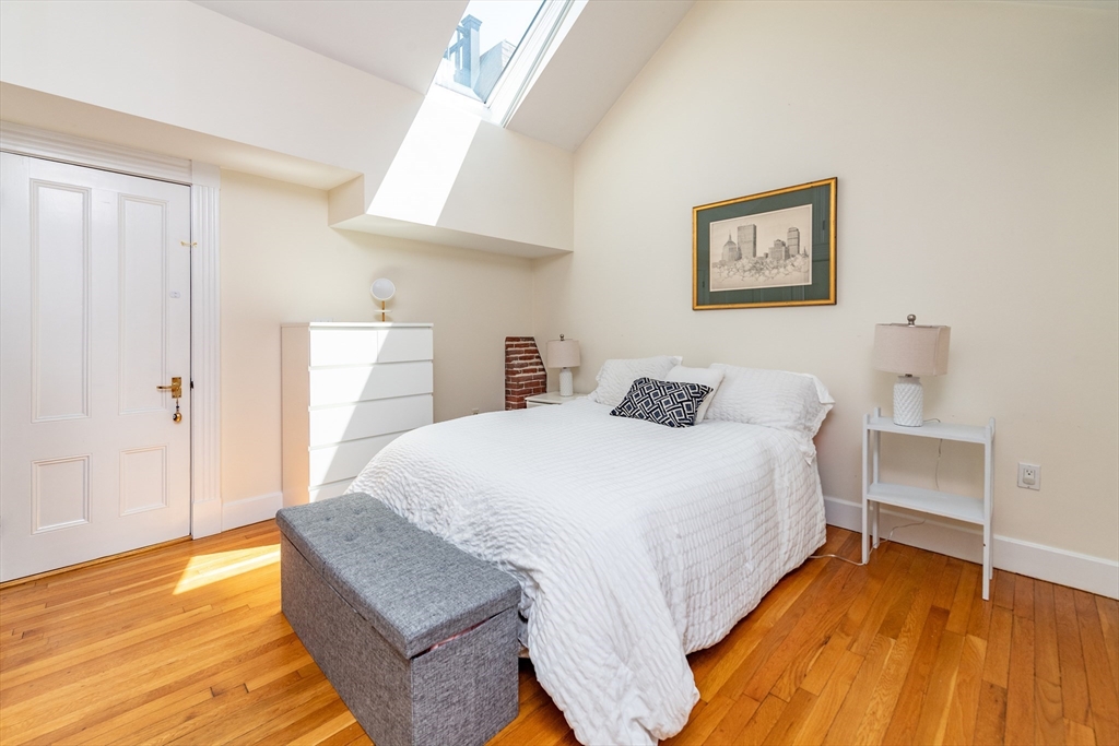 13 Harvard Street, Unit 3 Boston, MA 02129 - Photo 10 of 14 a spacious bedroom with a bed and a table