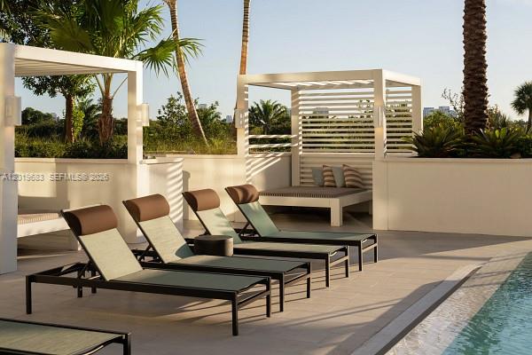 3900 Alton Road, Unit 503 Miami Beach, FL 33140 - Photo 34 of 37 a view of a chairs and table in a patio