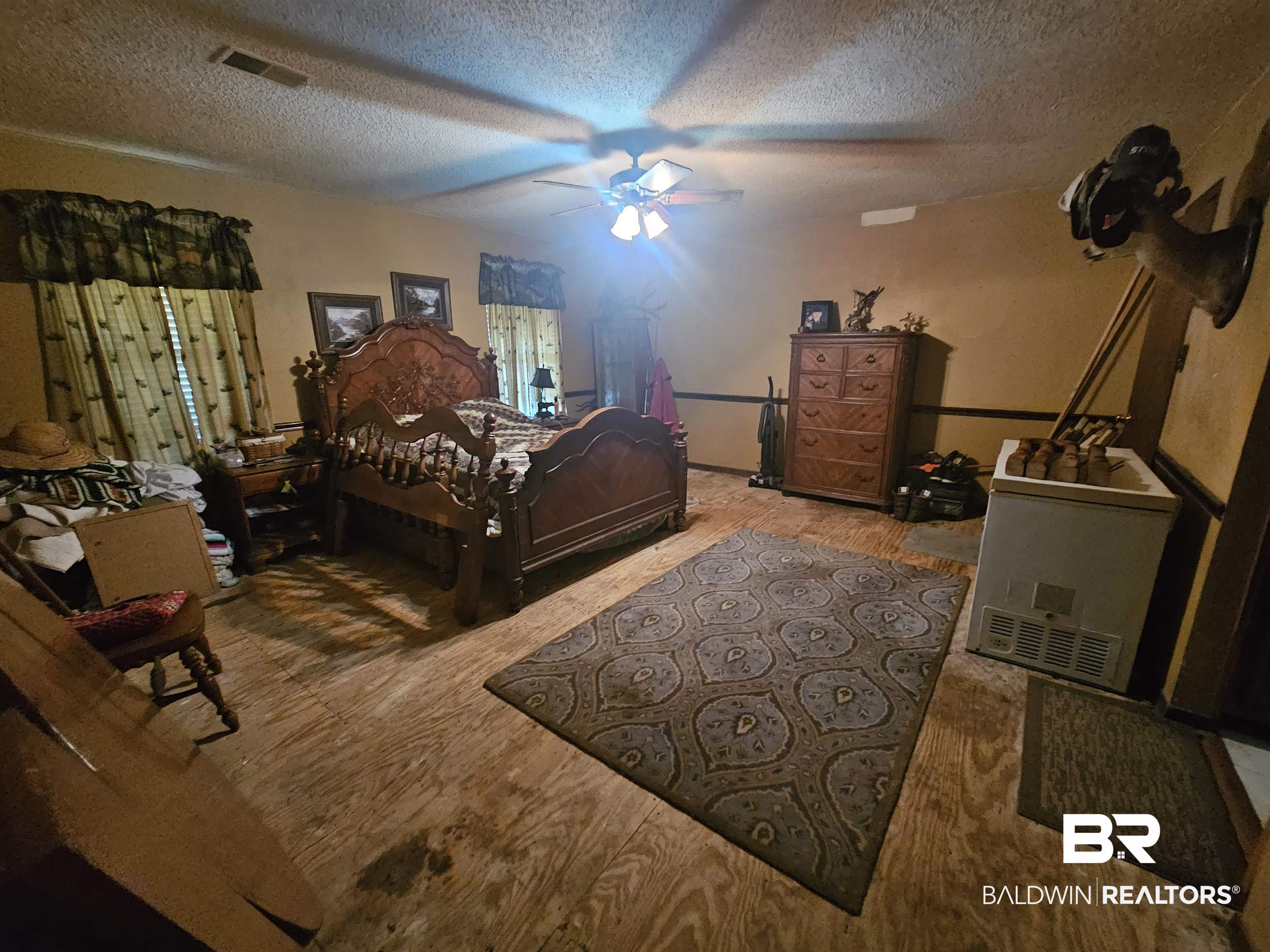 1818 Old Fannie Road Flomaton, AL 36441 - Photo 13 of 20 Bedroom with a textured ceiling, wood finished floors, and a ceiling fan