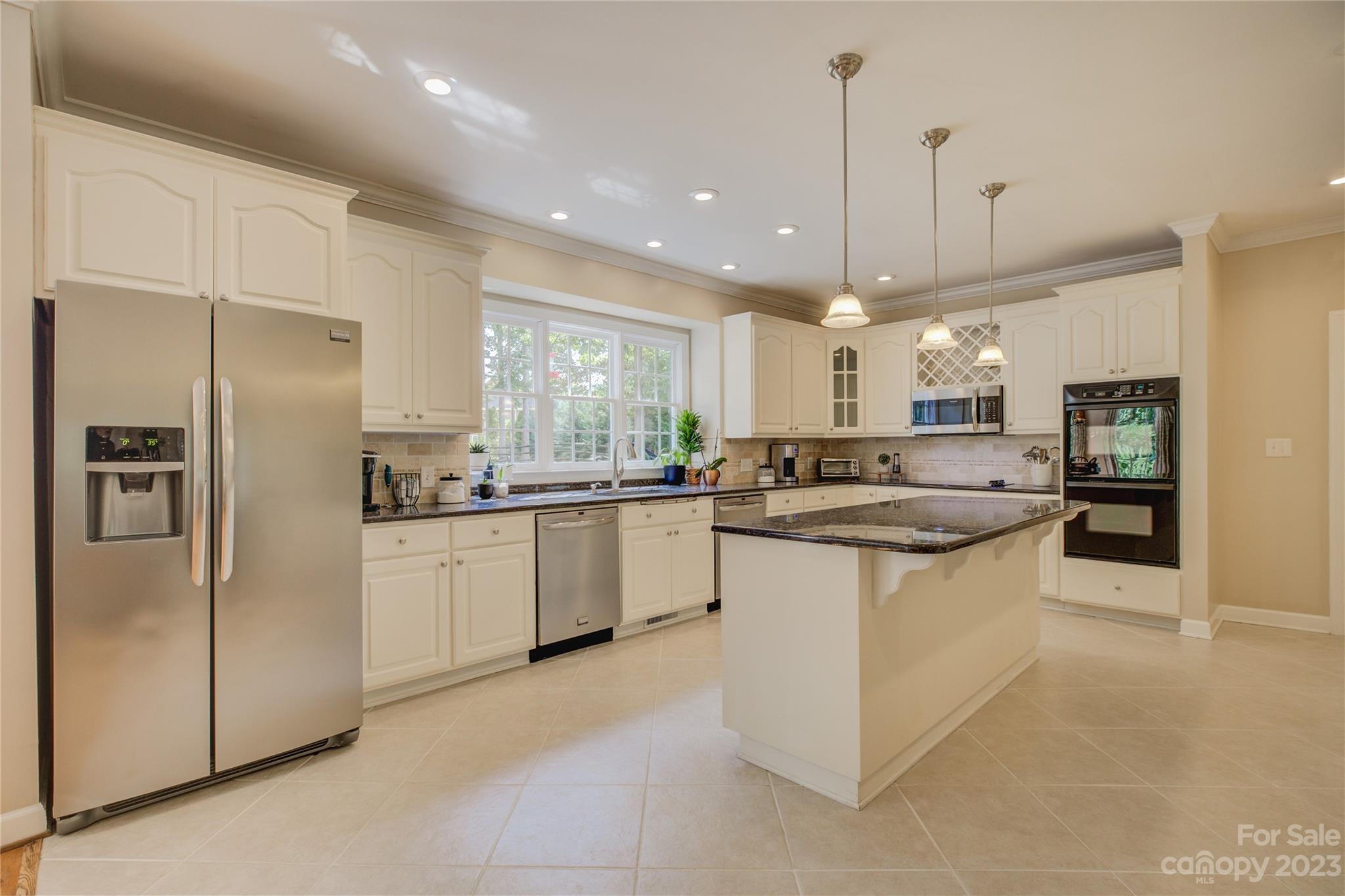 12017 Forest Home Drive Fort Mill, SC 29708 - Photo 14 of 44 a kitchen with stainless steel appliances granite countertop a refrigerator a sink and a oven