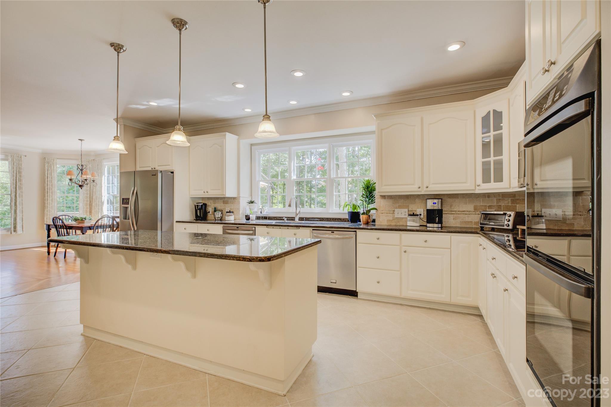 12017 Forest Home Drive Fort Mill, SC 29708 - Photo 15 of 44 a kitchen with stainless steel appliances granite countertop a sink a stove and a granite counter tops