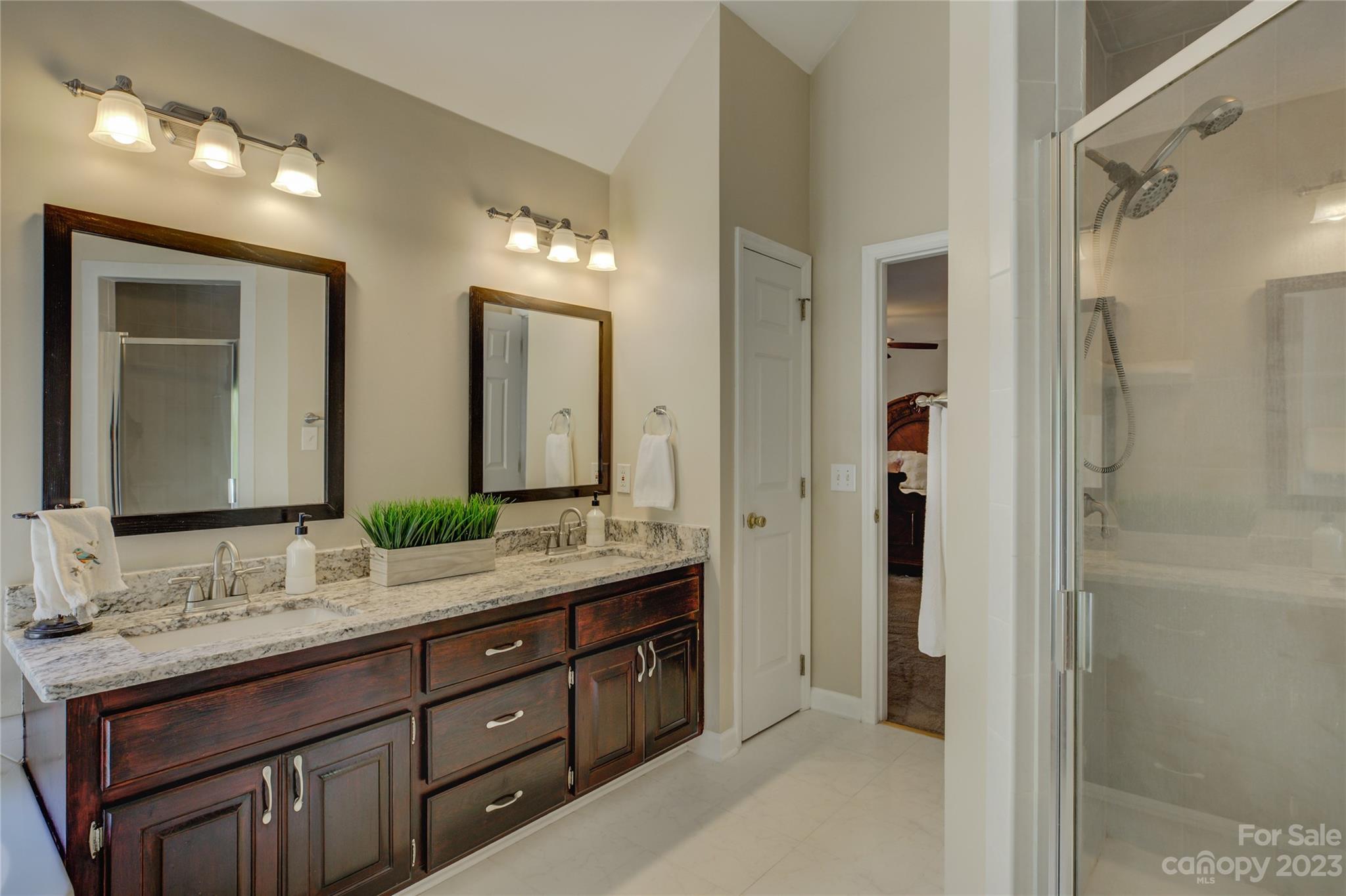 12017 Forest Home Drive Fort Mill, SC 29708 - Photo 29 of 44 a bathroom with a double vanity sink and a mirror