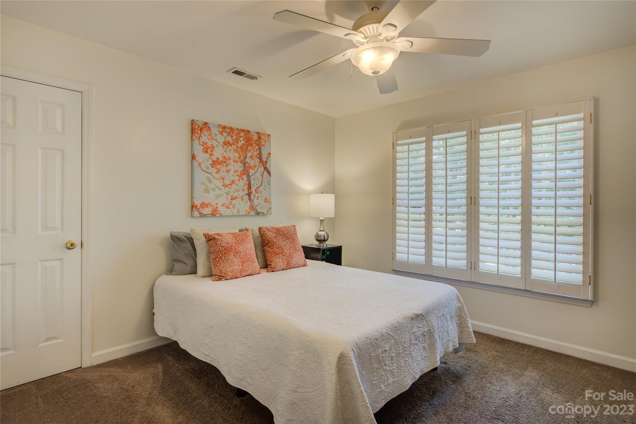 12017 Forest Home Drive Fort Mill, SC 29708 - Photo 30 of 44 a bedroom with a large bed and a ceiling fan