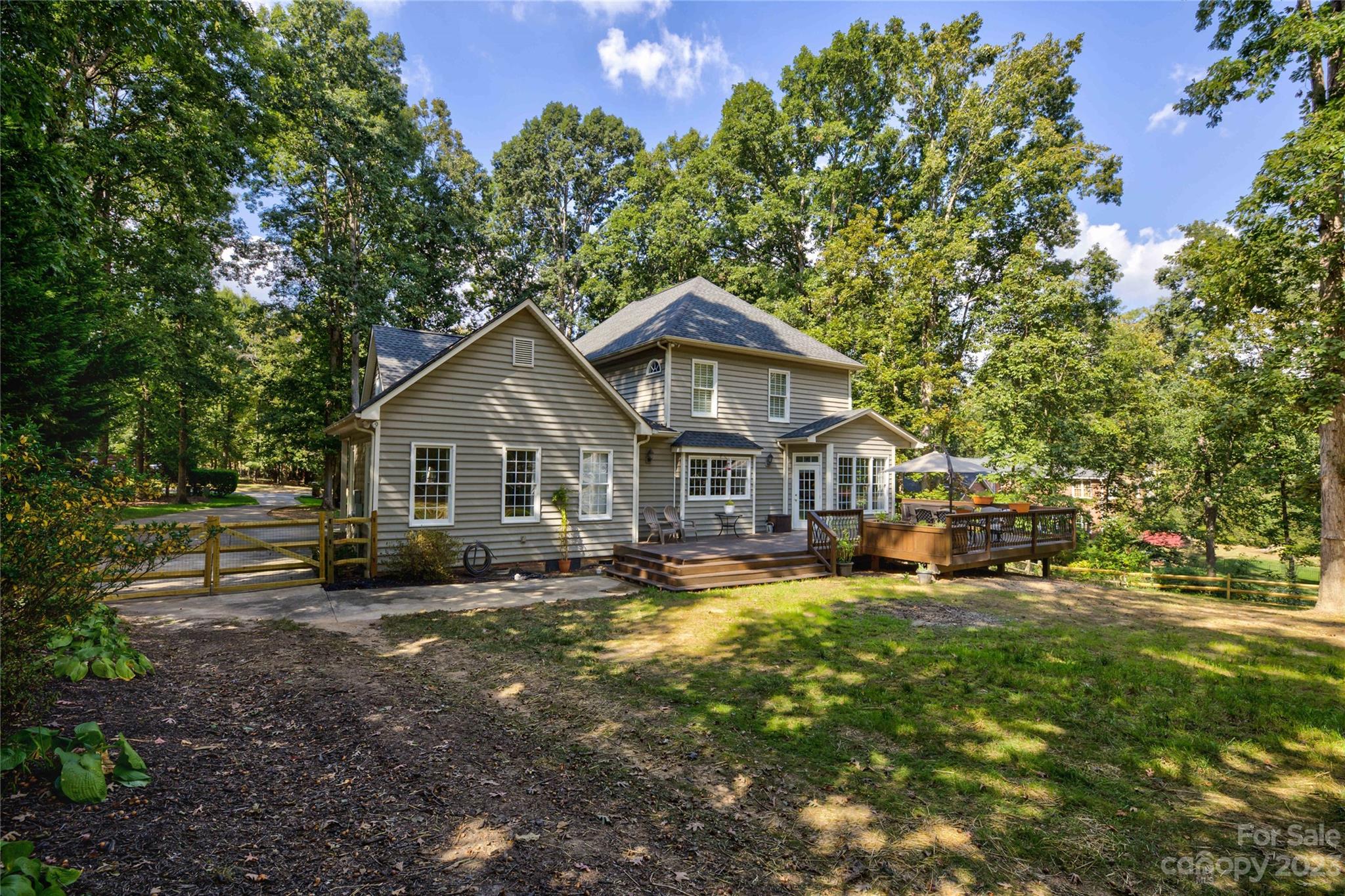 12017 Forest Home Drive Fort Mill, SC 29708 - Photo 36 of 44 a view of a house with a big yard and large trees