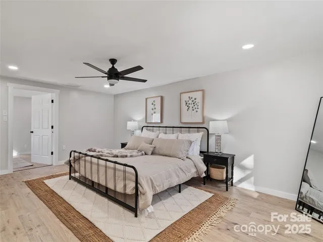 a bedroom with a bed and a ceiling fan