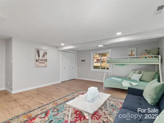 a living room with furniture and view of kitchen