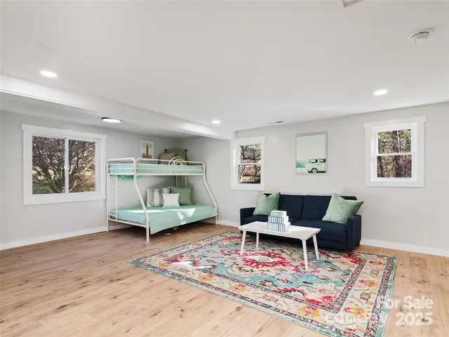 a living room with furniture and wooden floor