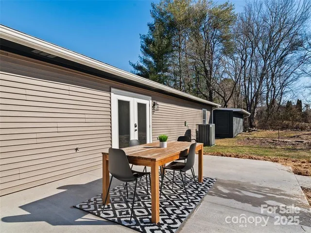 a view of a patio with table and chairs and wooden floor