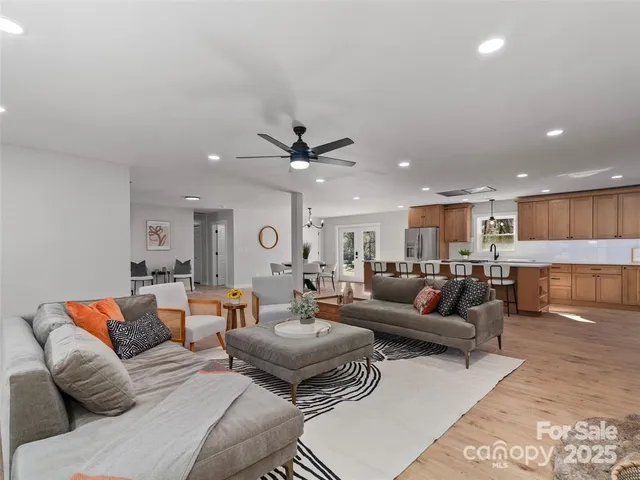 a living room with furniture and a glass door