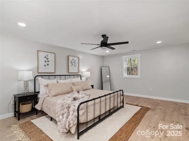 a bedroom with a large bed and a lamp