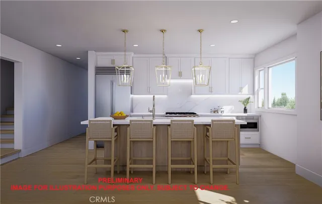 a kitchen with a dining table chairs and wooden floor