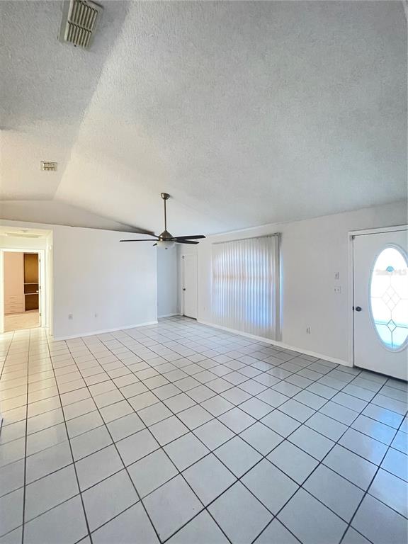 11322 Topaz Street Spring Hill, FL 34608 - Photo 11 of 41 an empty room with staircase and mirror
