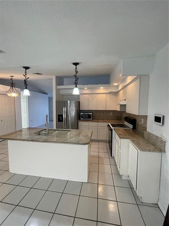 11322 Topaz Street Spring Hill, FL 34608 - Photo 12 of 41 a large kitchen with granite countertop a large counter top and sink
