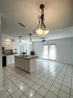 a kitchen with stainless steel appliances a sink a counter space cabinets and appliances