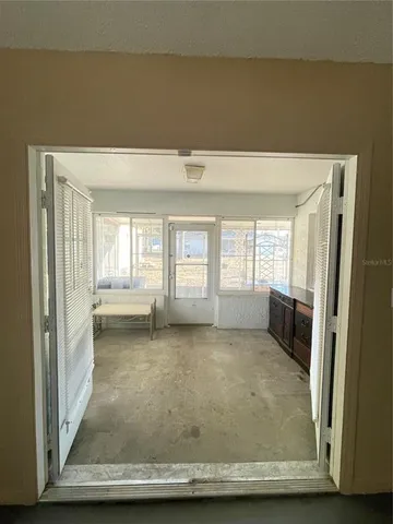 a view of an empty room with a fireplace