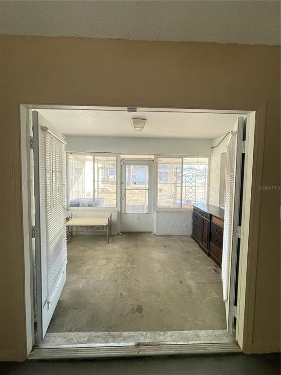 11322 Topaz Street Spring Hill, FL 34608 - Photo 17 of 41 a view of an empty room with a fireplace