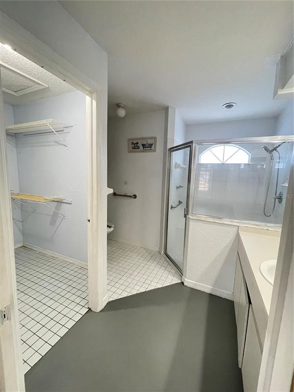 11322 Topaz Street Spring Hill, FL 34608 - Photo 18 of 41 a bathroom with a sink and a glass door shower