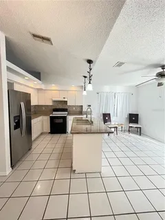 a kitchen with stainless steel appliances a refrigerator sink and cabinets