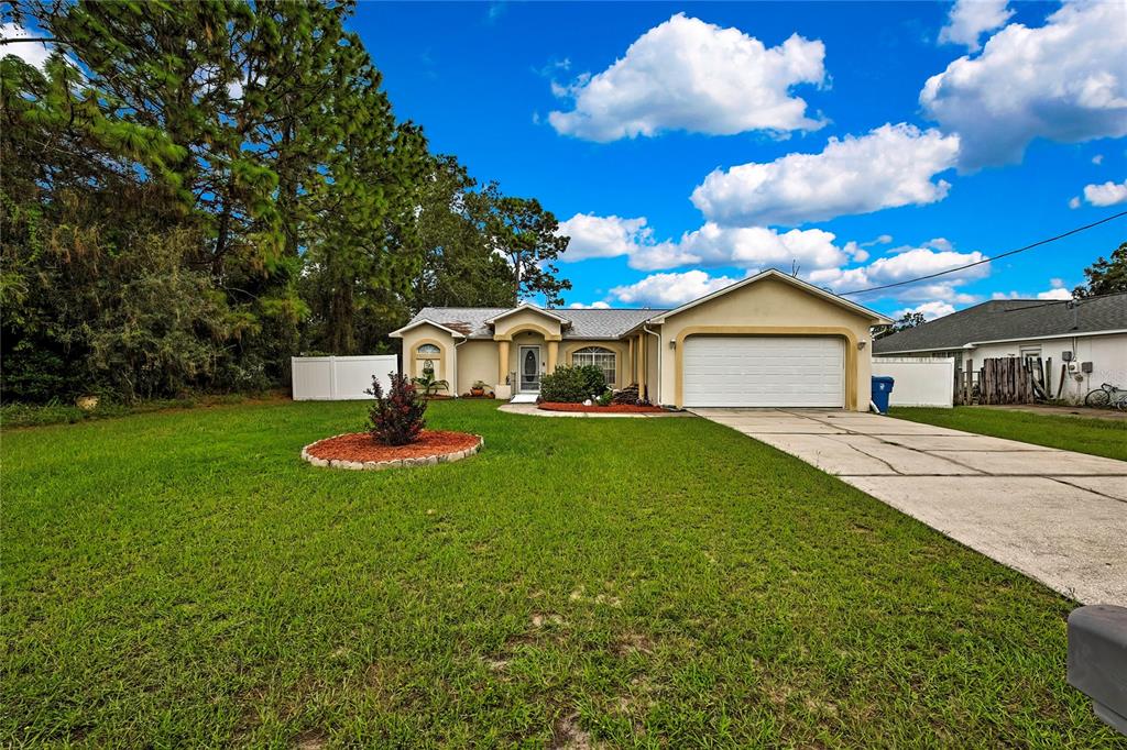 11322 Topaz Street Spring Hill, FL 34608 - Photo 29 of 41 a front view of a house with garden