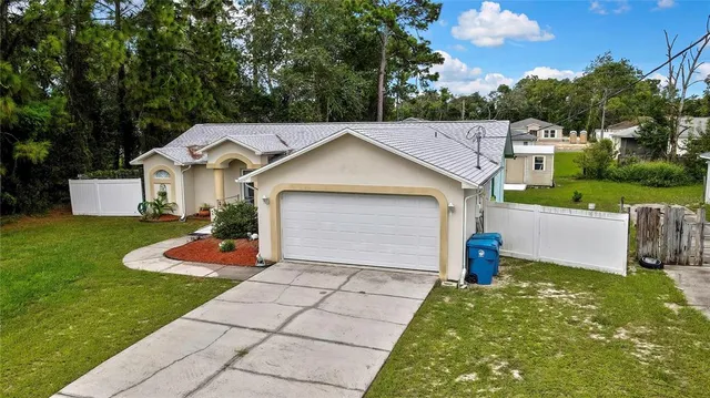 a front view of a house with a yard and trees