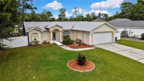 a backyard of a house with table and chairs