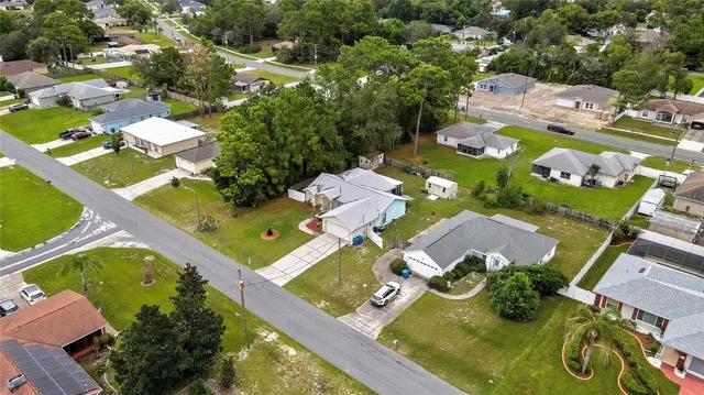 an aerial view of multiple houses with yard